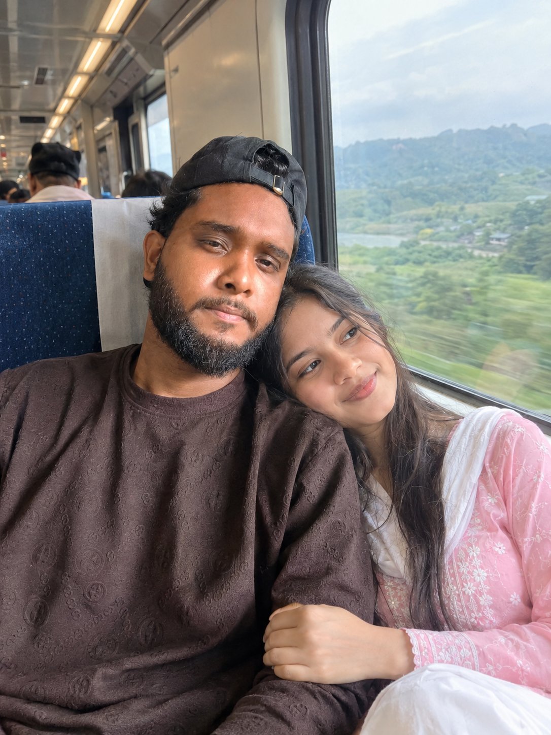 Add a girlfriend to the scene who is traveling by train.